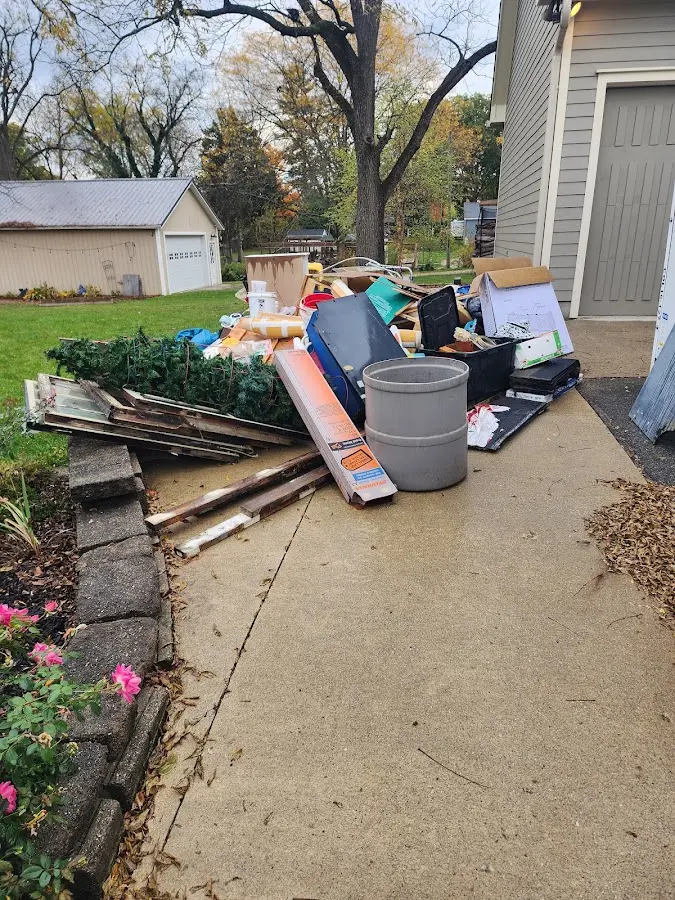 Dumpster being loaded with debris for Roofing Dumpster Rental in Lynn